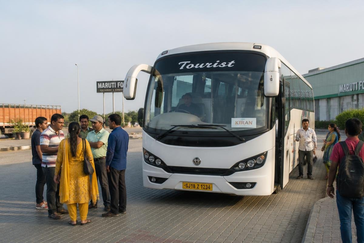 Indian travellers standing beside a modern air conditioned white tourist coach at a highway stop